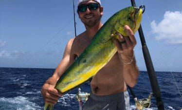 deep-sea-fishing-man holding up his catch